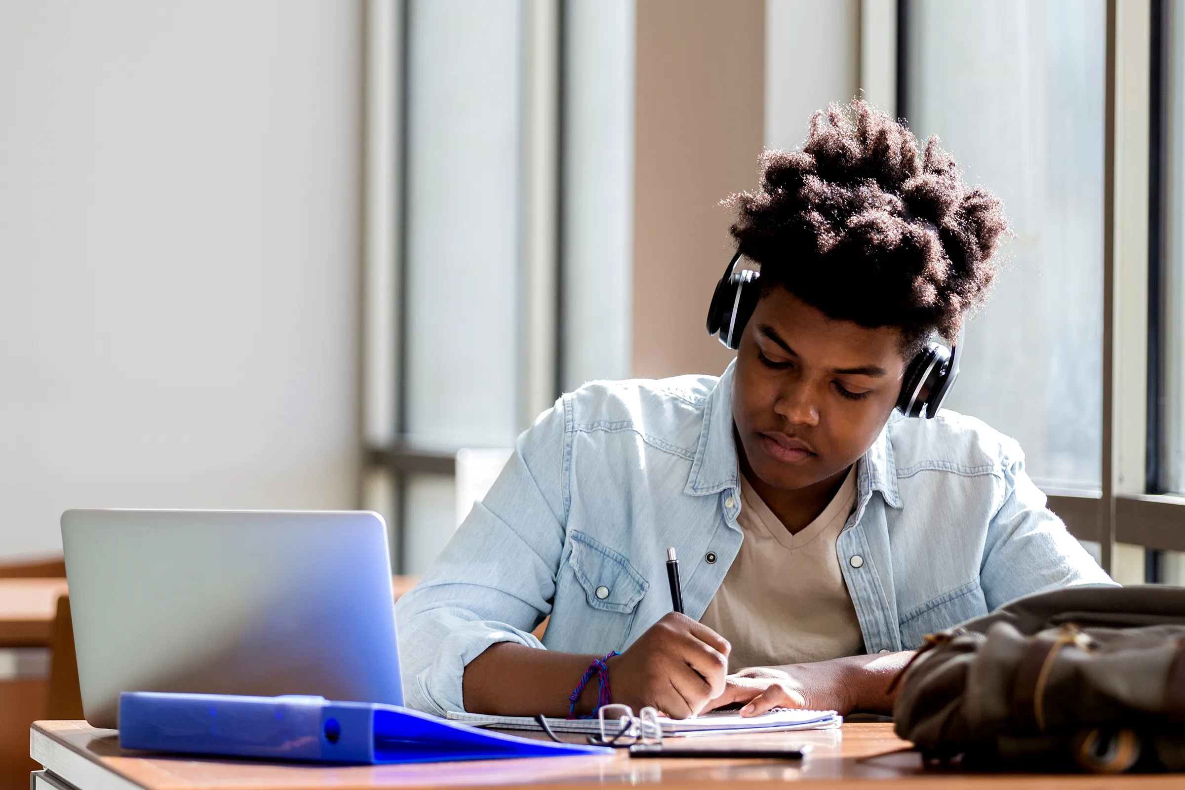 Student with headphones practicing on laptop