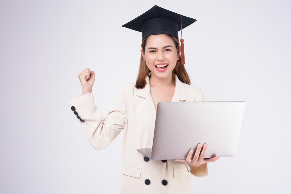 Graduate celebrating with open laptop